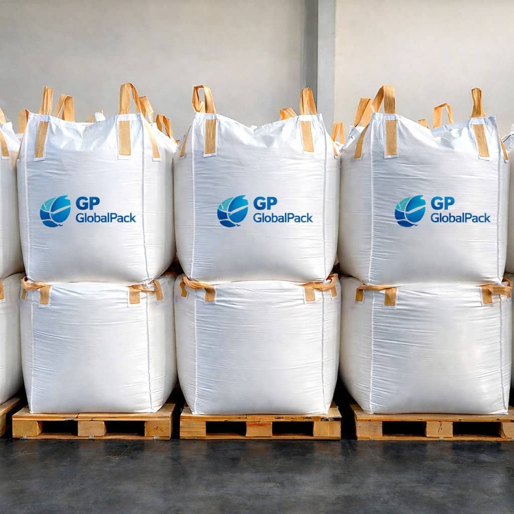 Branded white bulk bags stacked on wooden pallets for industrial export and shipping application