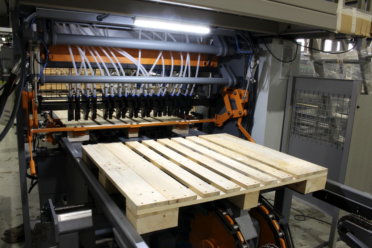 Automated Pallet Nailing and Assembly Line Automated wooden pallet assembly line constructing wooden pallets on conveyor